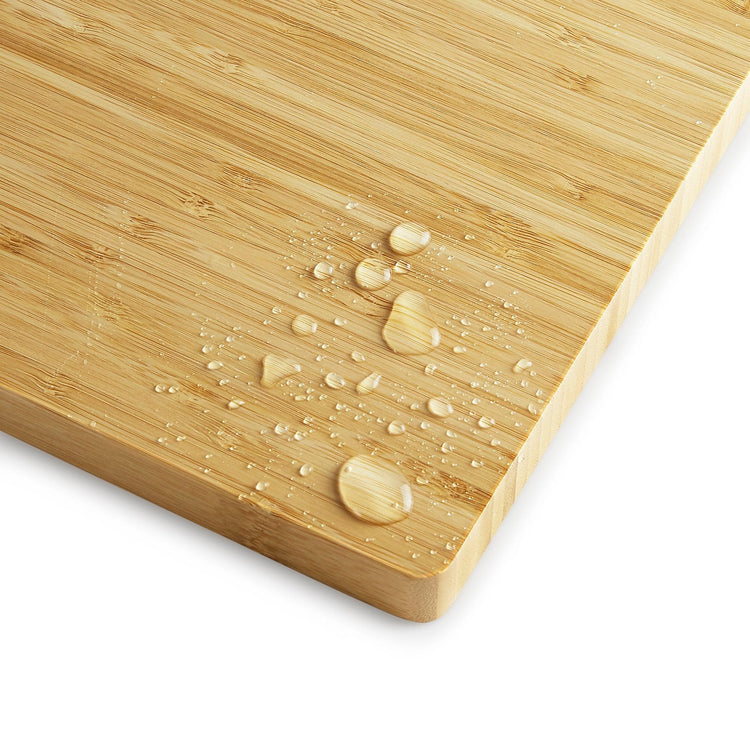 Water droplets beading on the bamboo cutting board surface.