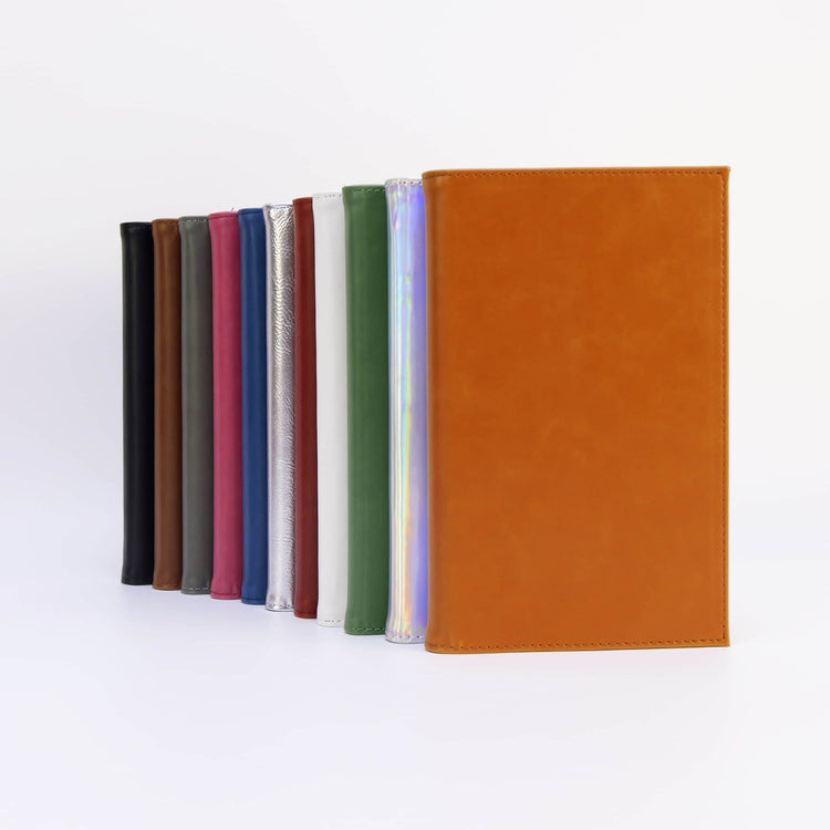 Journal notebooks standing upright in an assortment of colors.