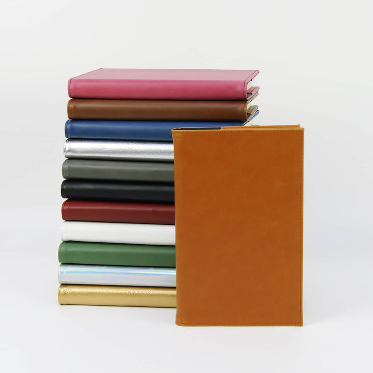 Rawhide journal notebook displayed with a stack of color options.