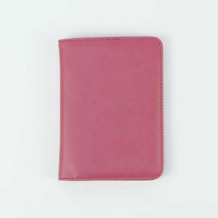 Pink passport wallet shown closed against white.