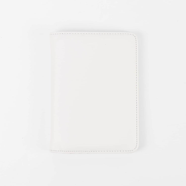 White passport wallet shown closed against white.