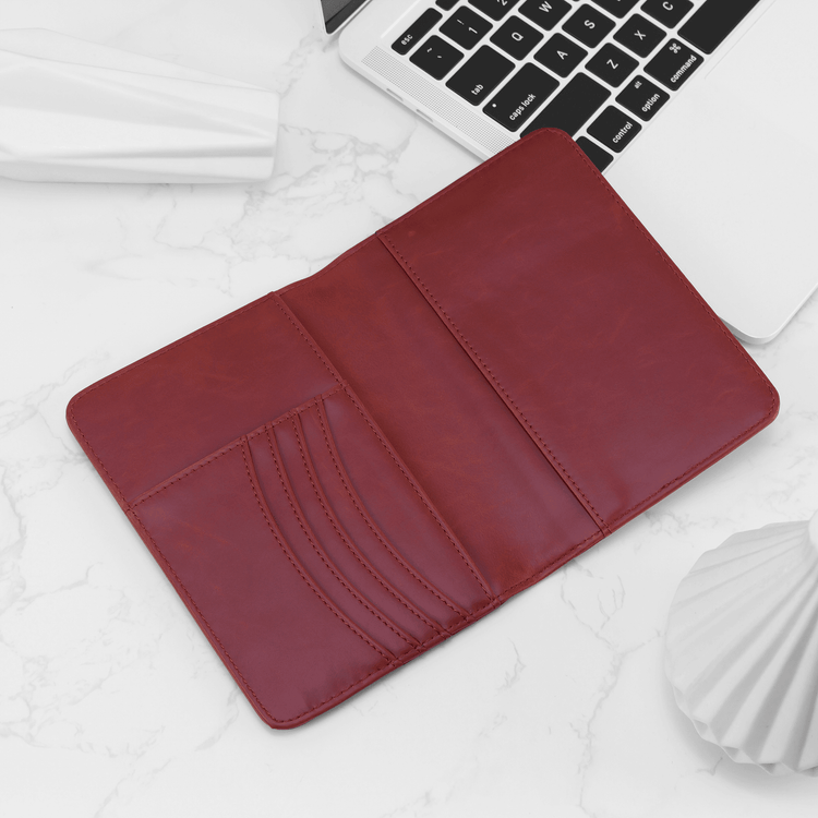 Red passport wallet open to show card slots and passport pocket.