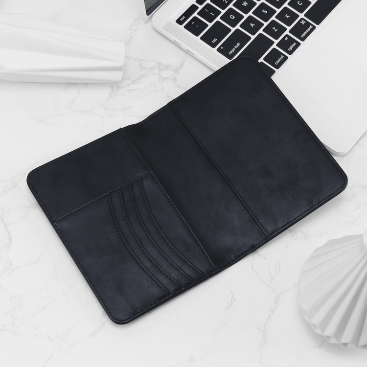 Black passport wallet open to show card slots and passport pocket.