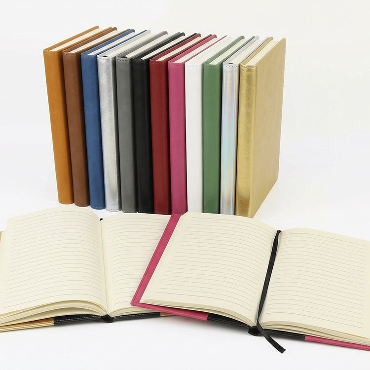 Assorted journal notebooks arranged with one open to lined pages.