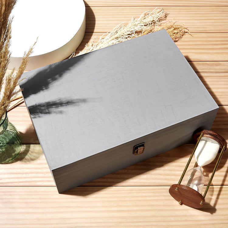Closed gray memory box styled on a tabletop with accessories.