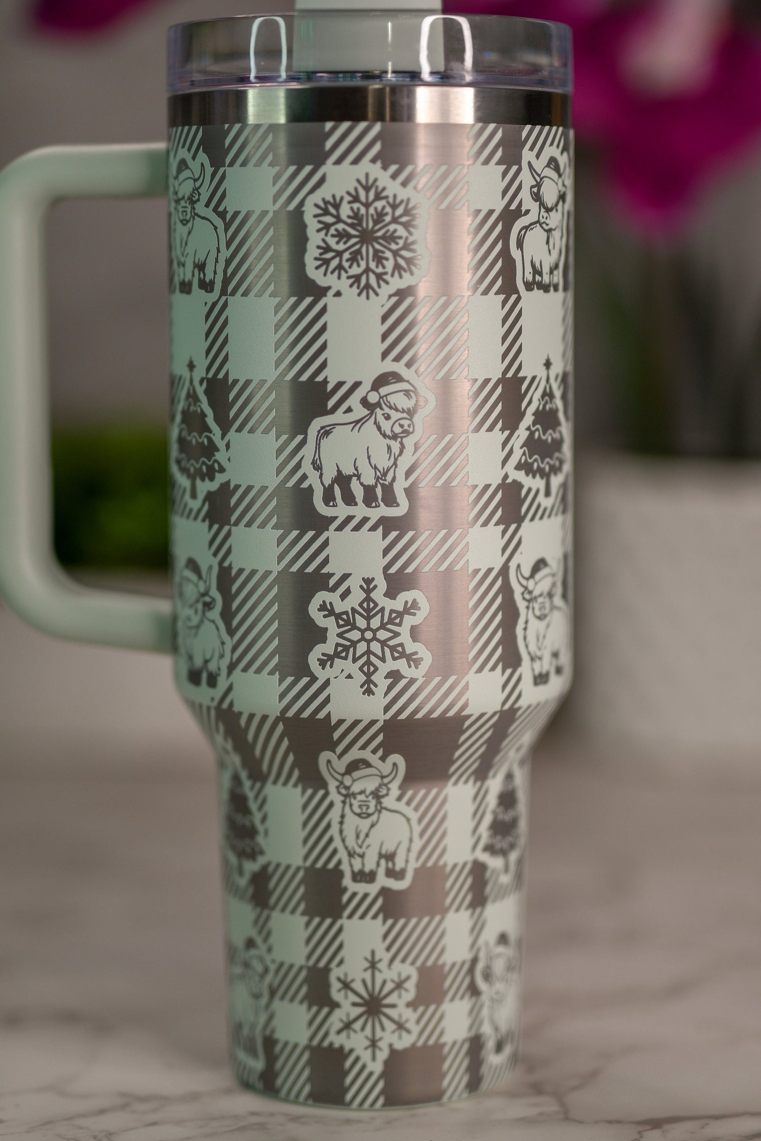 a plaid coffee cup with a bear and snowflakes on it