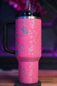 a pink coffee cup with a black lid