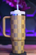 a yellow and brown cup with a straw in it