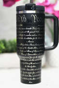 a black travel mug with writing on it