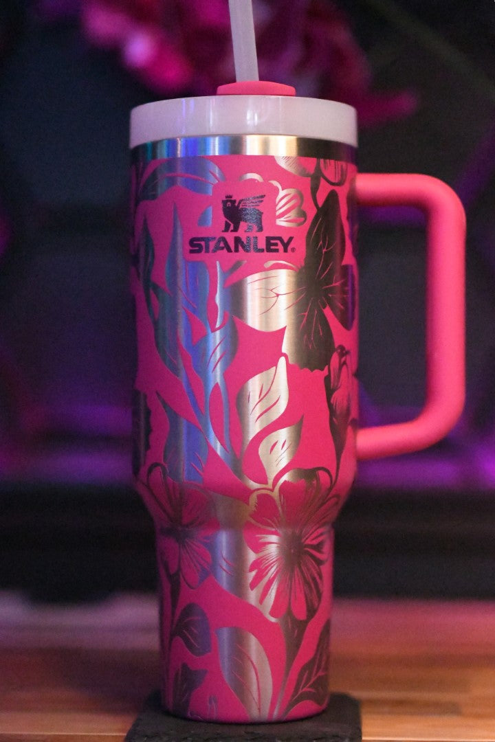 a pink coffee cup with a straw sticking out of it