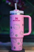 a pink cup with a hello kitty design on it