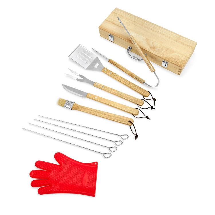 Complete barbecue tool set arranged beside its wooden case and red glove.