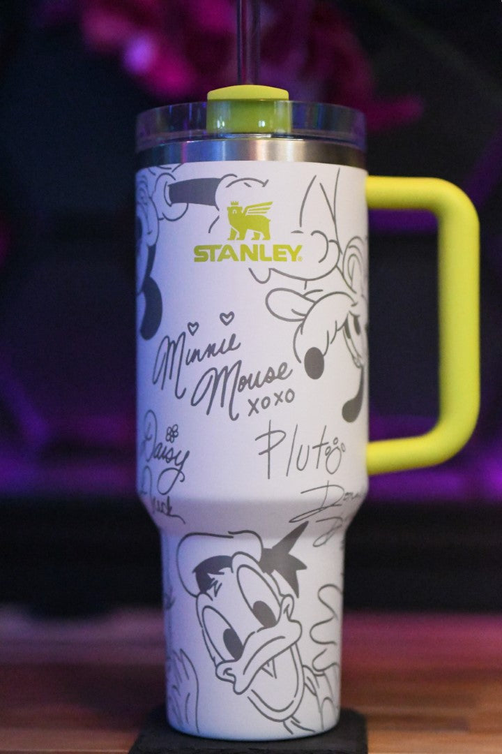 a travel mug with a mickey mouse design on it