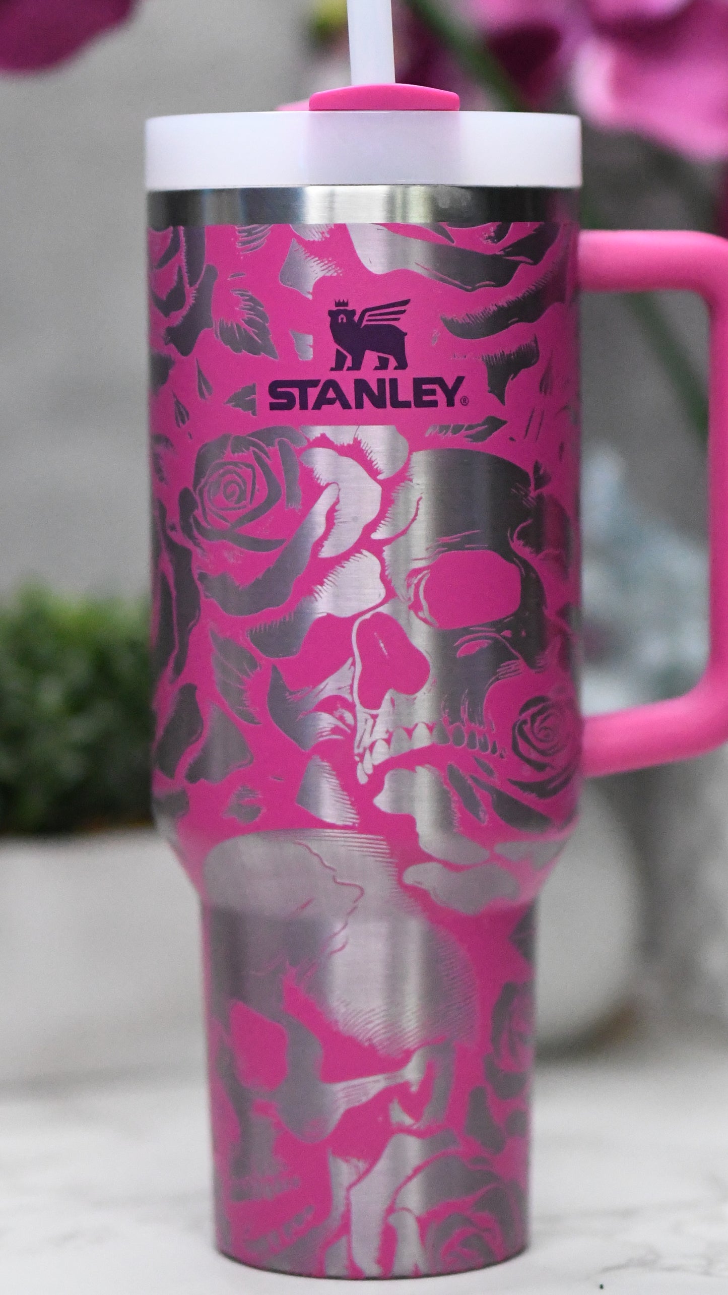 a close up of a pink cup with flowers on it