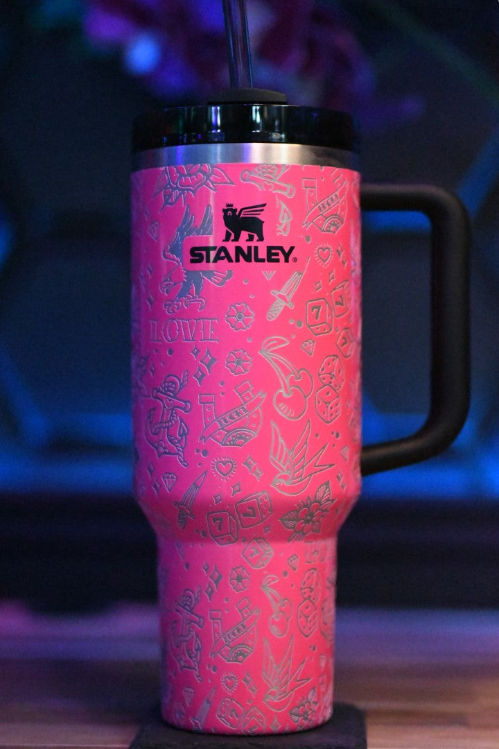 a pink coffee cup with a straw in it