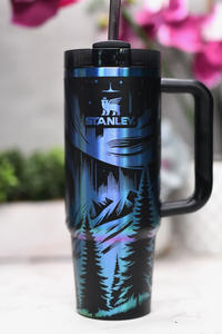 a blue and black travel mug with a black handle