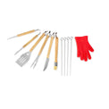 Barbecue utensils, skewers, and red grilling glove arranged together.
