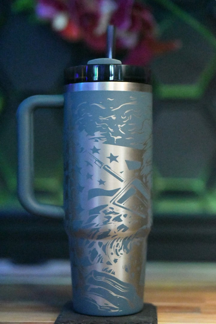 a stainless steel travel mug sitting on top of a wooden table