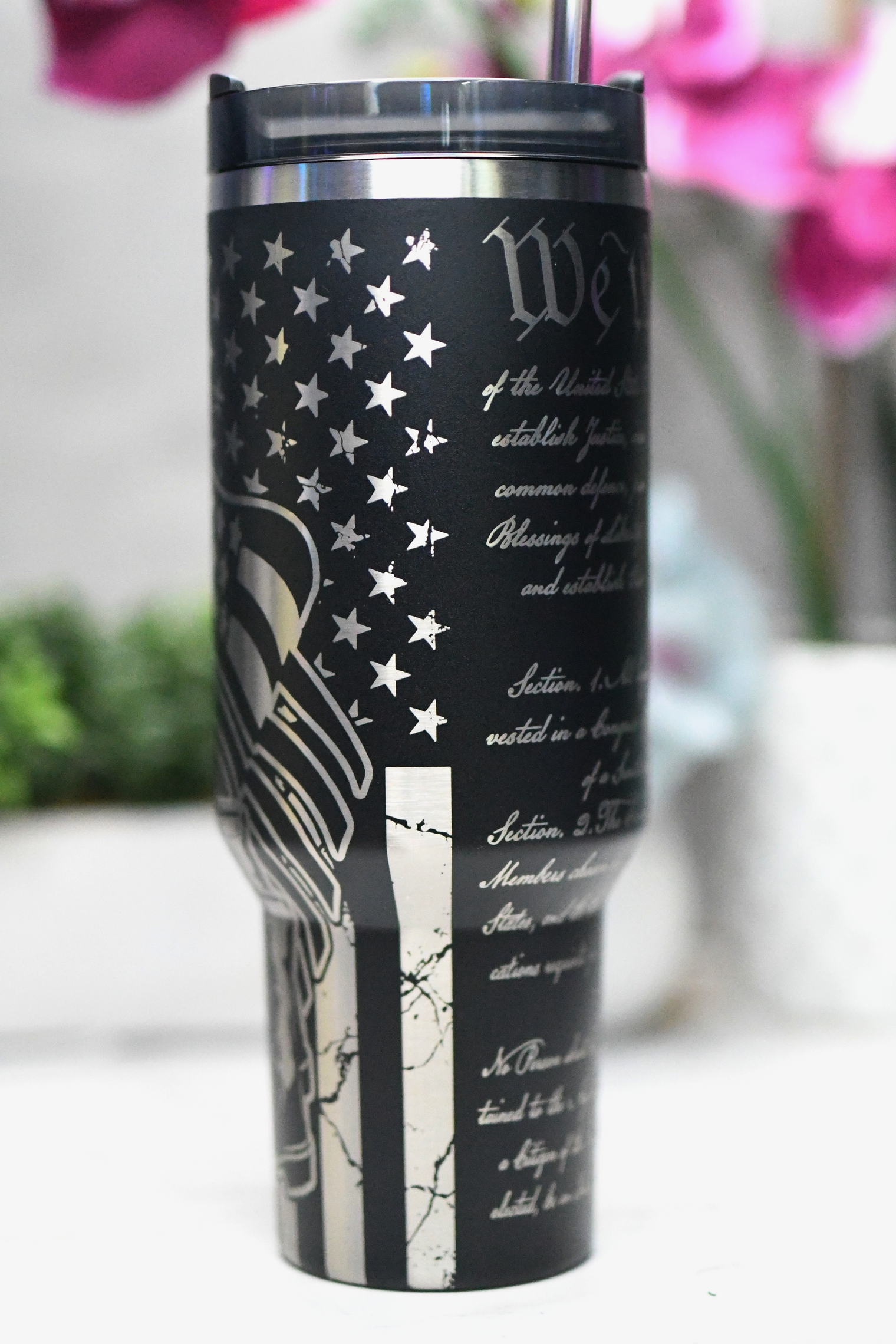 a black and white tumbler with an american flag on it