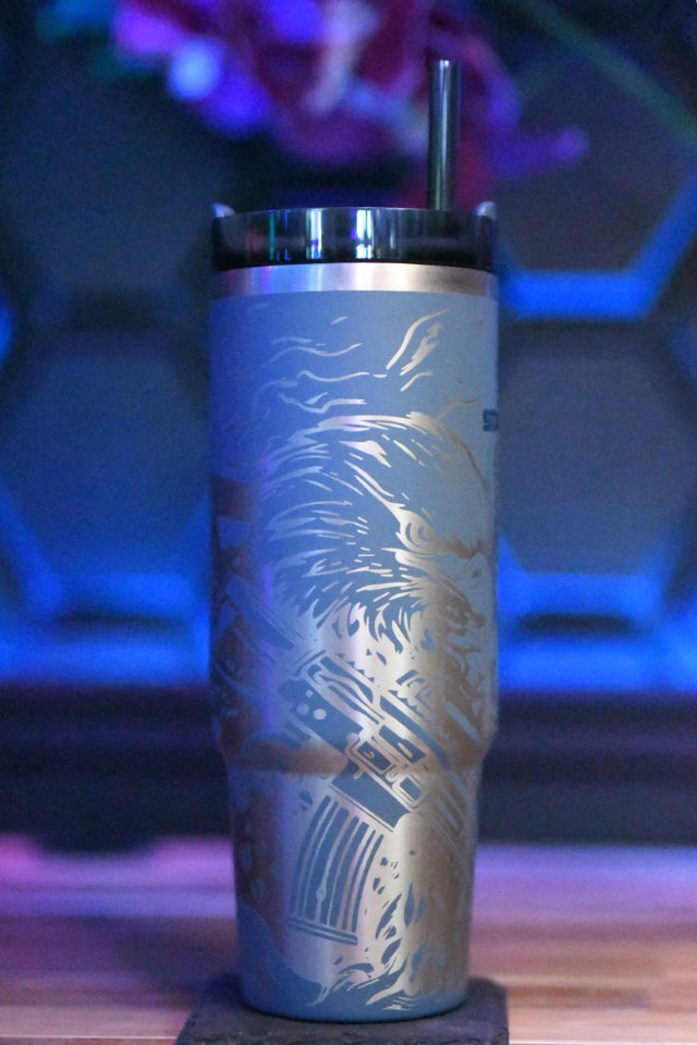 a stainless steel tumbler sitting on top of a wooden table