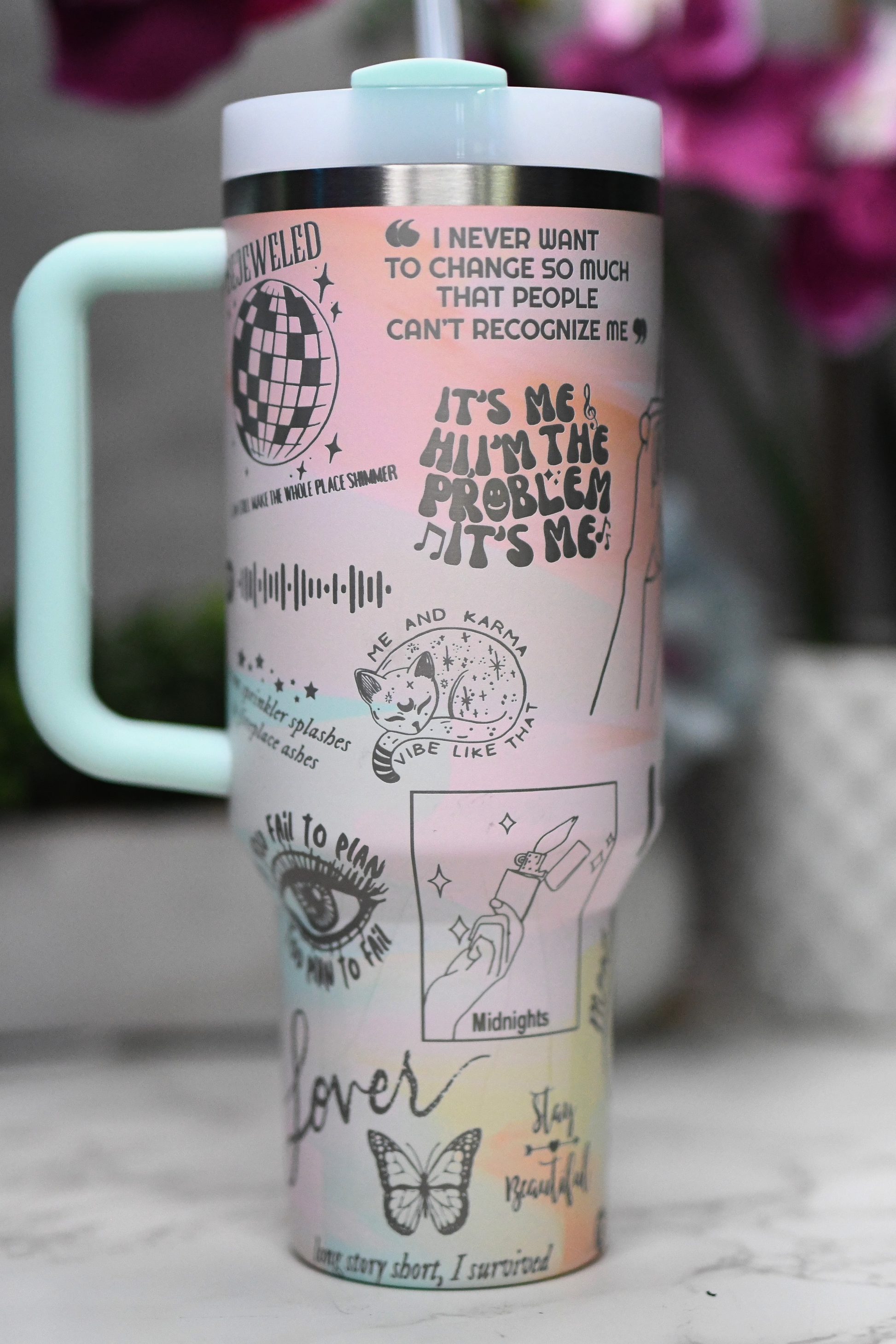 a travel mug with stickers all over it