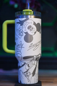 a mickey mouse travel mug sitting on top of a table