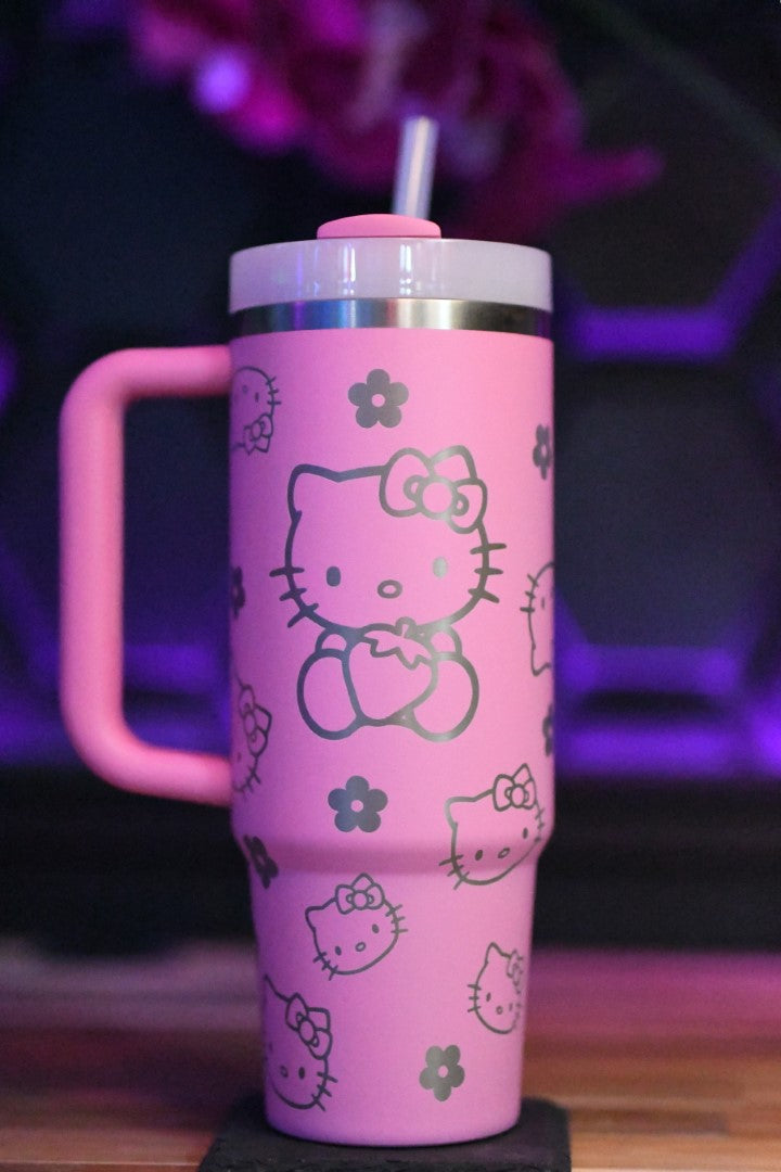 a hello kitty travel mug with a straw in it