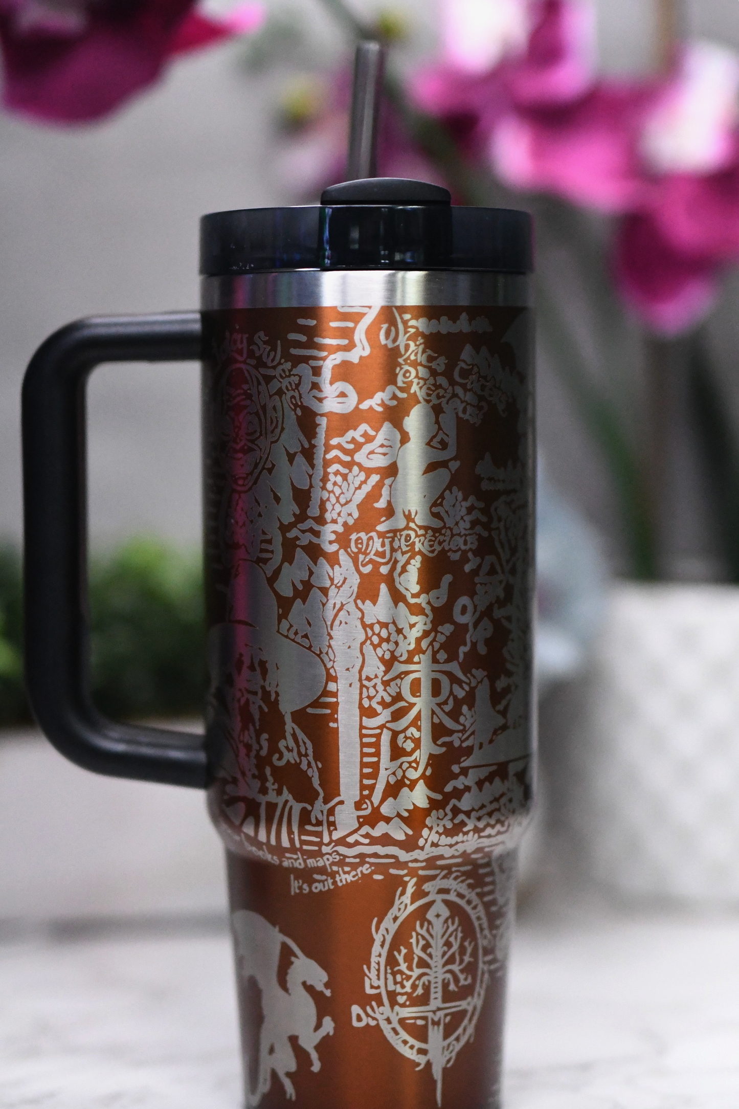 a travel mug with a straw sticking out of it