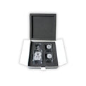 Engraved decanter and two rocks glasses nested in black fitted foam.