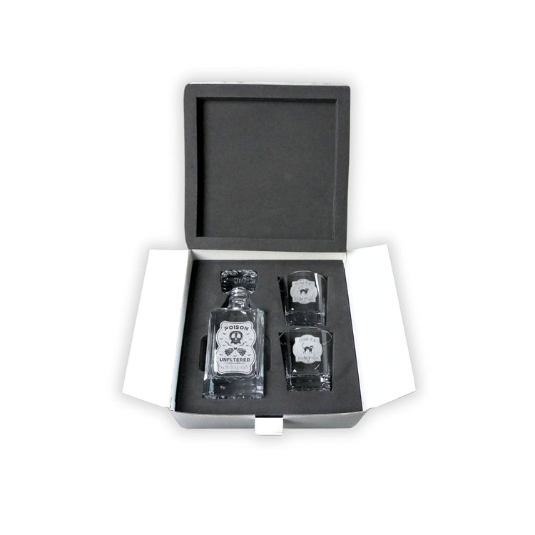 Engraved decanter and two rocks glasses nested in black fitted foam.