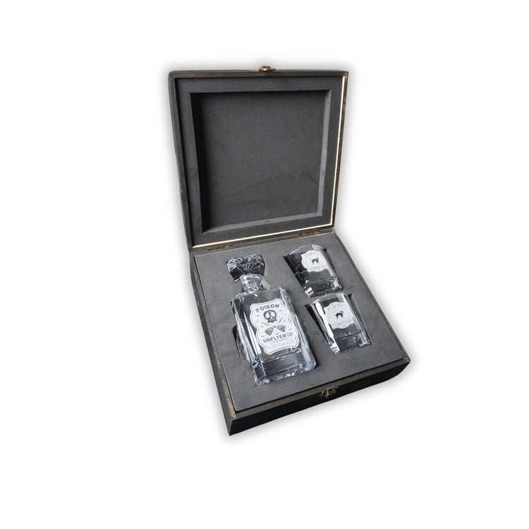 Whiskey decanter and two glasses displayed inside a walnut wood box.