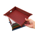 Red snap-corner valet tray held in one hand.