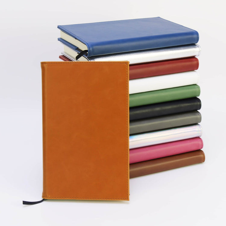 Rawhide journal notebook in front of stacked color options.