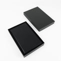 Black journal notebook with stitched cover and lined pages.