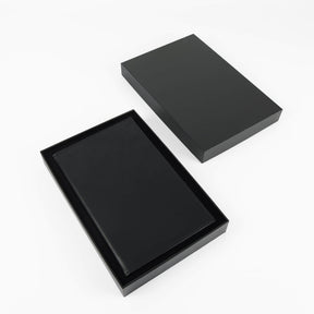 Black journal notebook with stitched cover and lined pages.