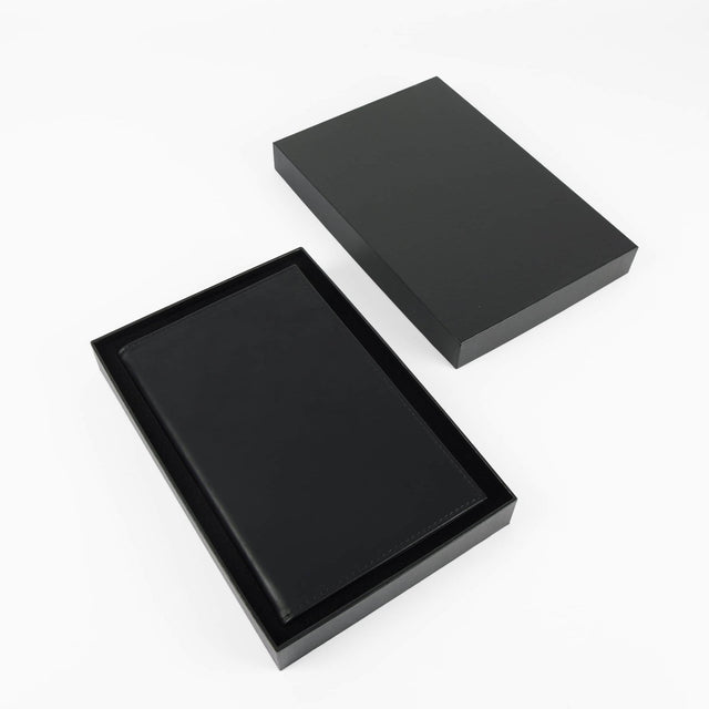 Black journal notebook with stitched cover and lined pages.