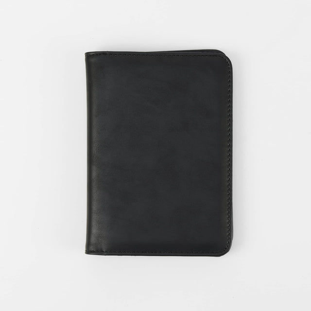Black passport wallet shown closed against white.