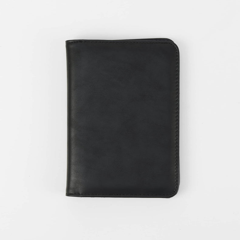 Black passport wallet shown closed against white.