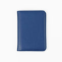 Blue passport wallet shown closed against white.