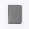 Gray passport wallet shown closed against white.