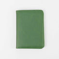 Green passport wallet shown closed against white.