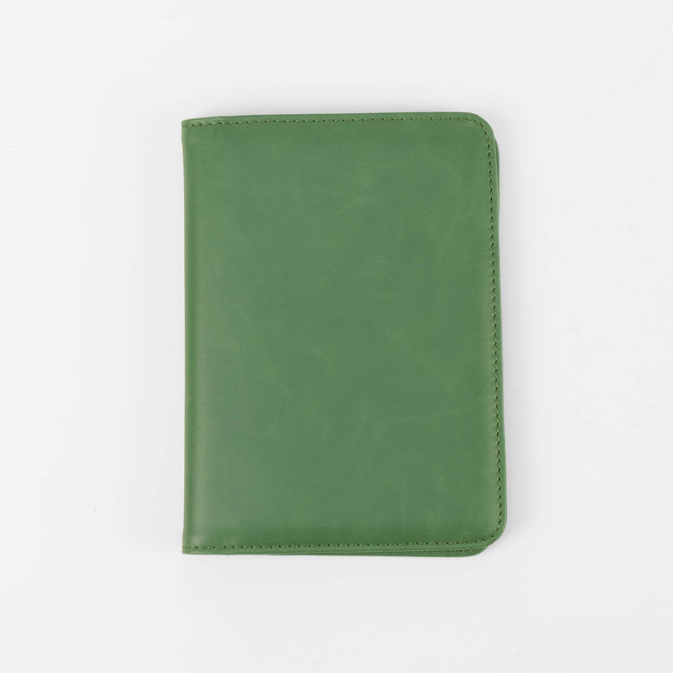 Green passport wallet shown closed against white.