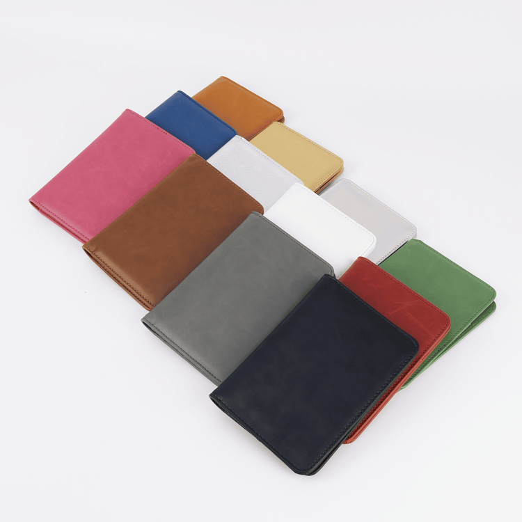 Assorted closed passport wallets fanned out by color.