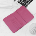 Pink passport wallet open to show the curved card slots.