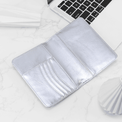 Silver passport wallet open to show card slots and passport pocket.