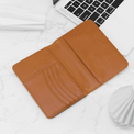 Rawhide passport wallet open to show card slots and passport pocket.