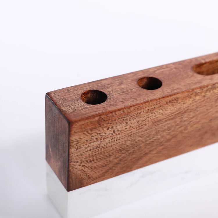 Close-up of the two pen openings in the acacia wood top.