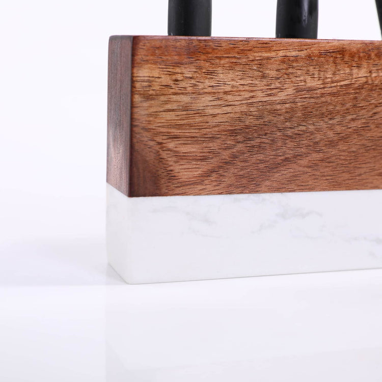 Close-up of the acacia wood front above the white marble base.