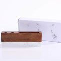 Desk organizer displayed in front of its marble-patterned gift box.