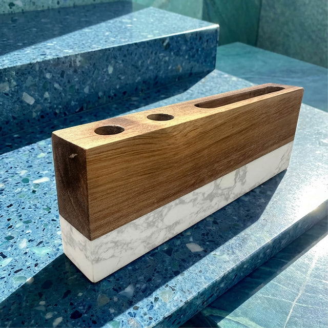 Marble and wood desk organizer displayed on a stone countertop.